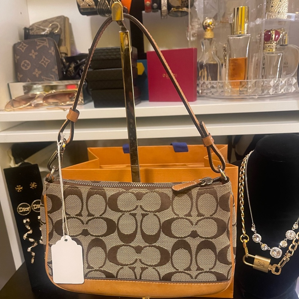 Coach shoulder purse or wristlet.